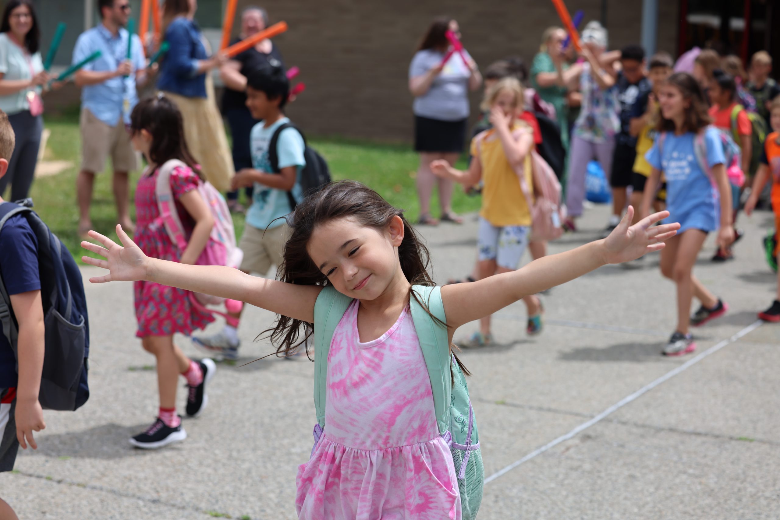 student with hands in the air, smiling