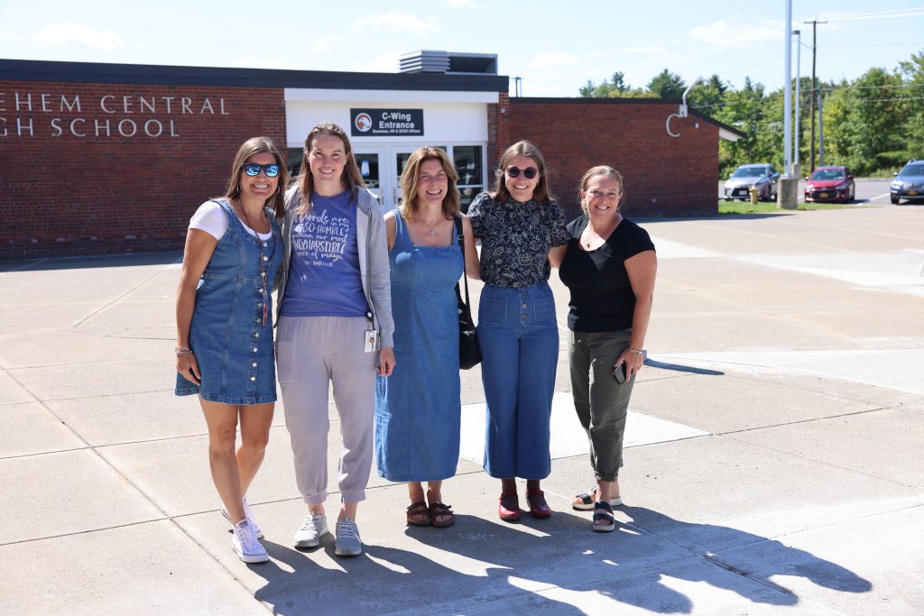 five people pose for photo