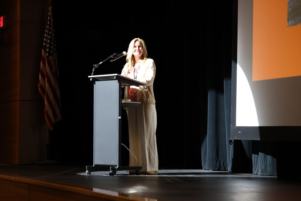 person speaks onstage