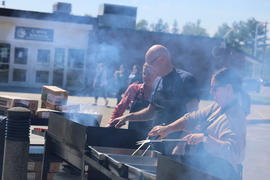 people in front of a hot grill