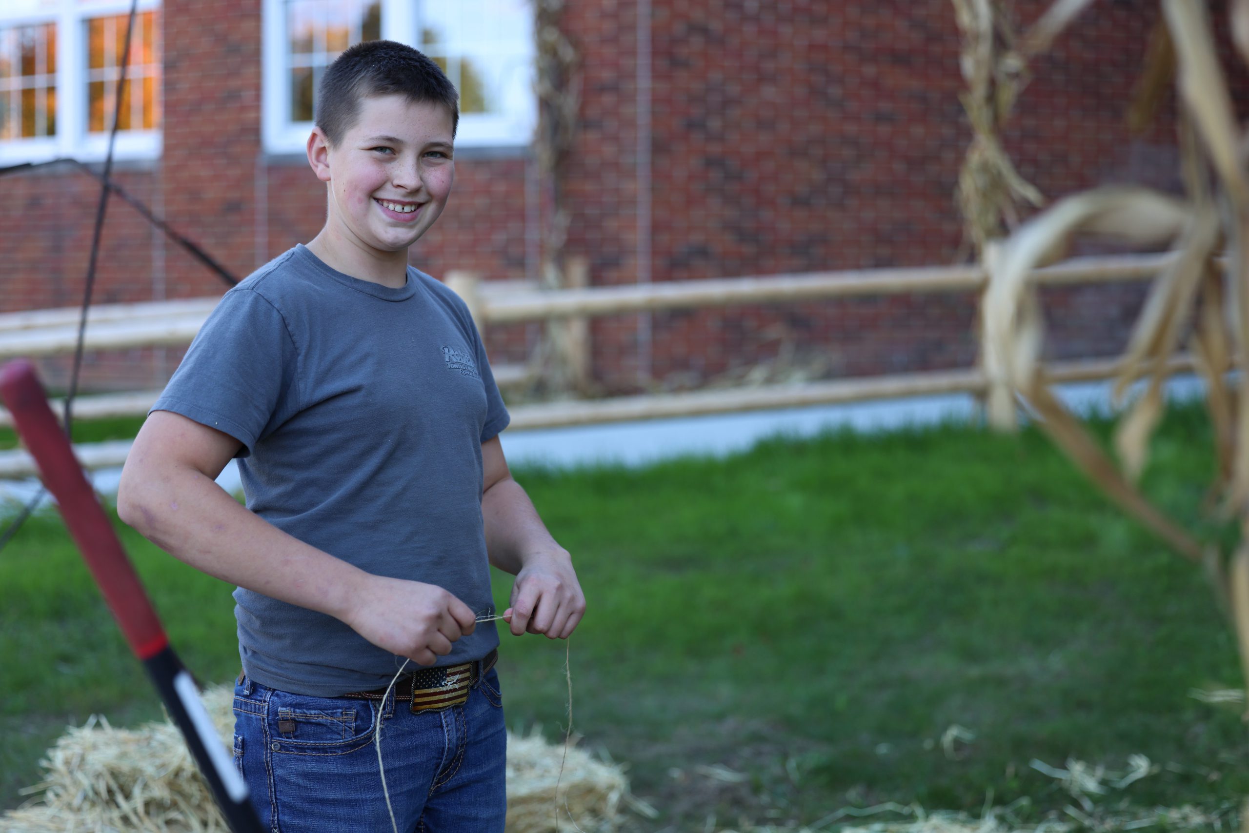 student in front of middle school