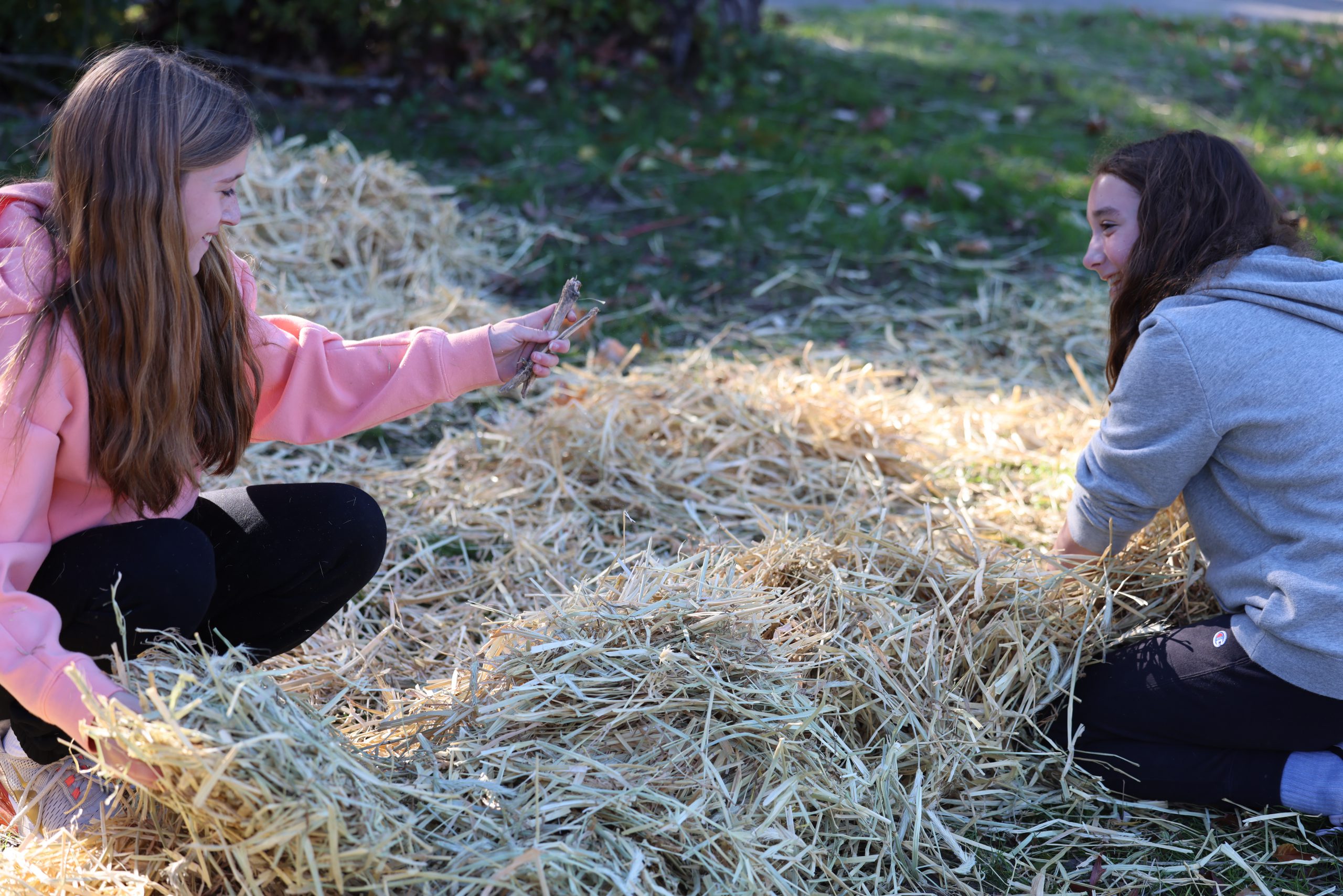 students in hay in front of middle school