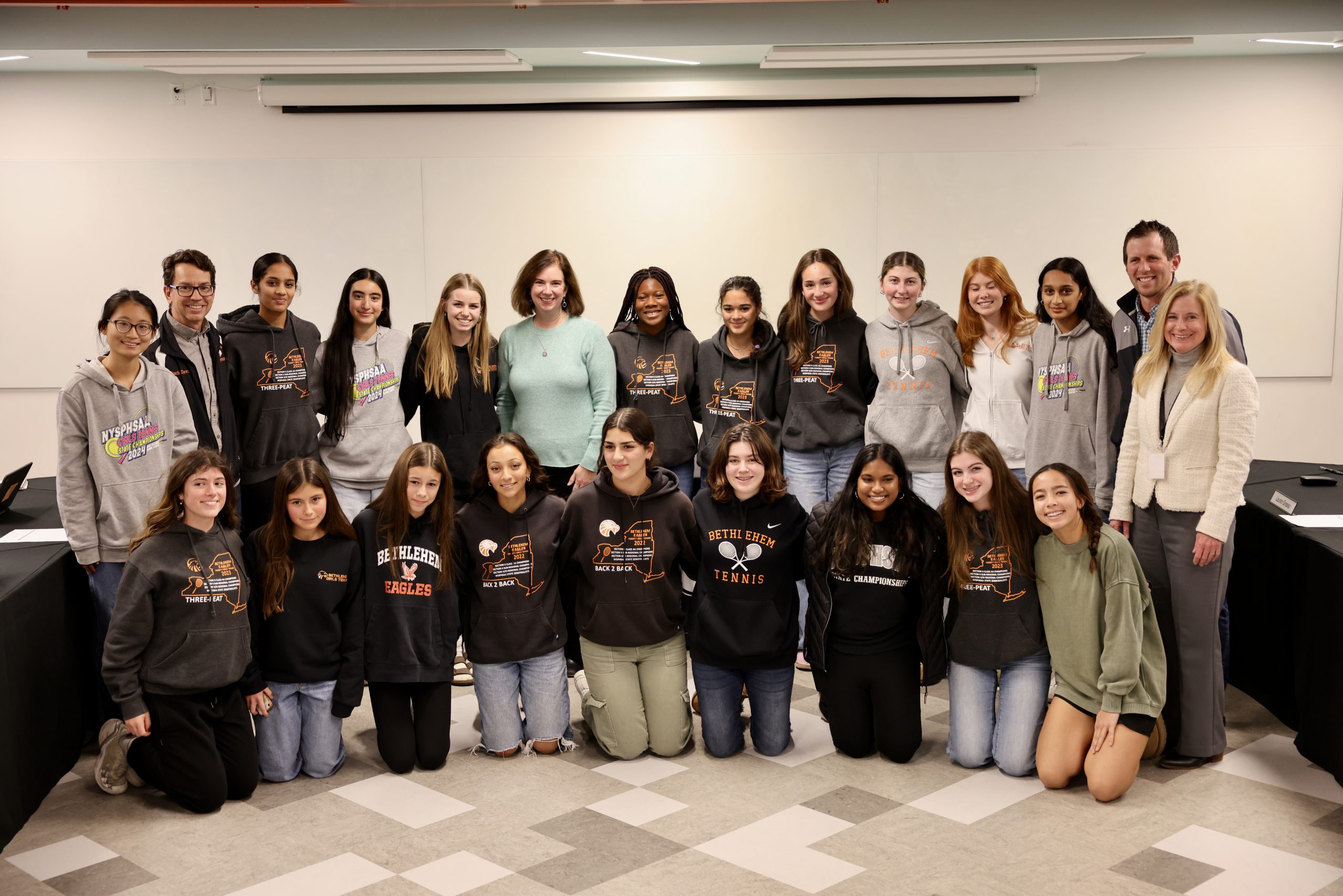 Photograph of Superintendent Jody Monroe, Board of Education President Holly Dellenbaugh, and the BC girls tennis team