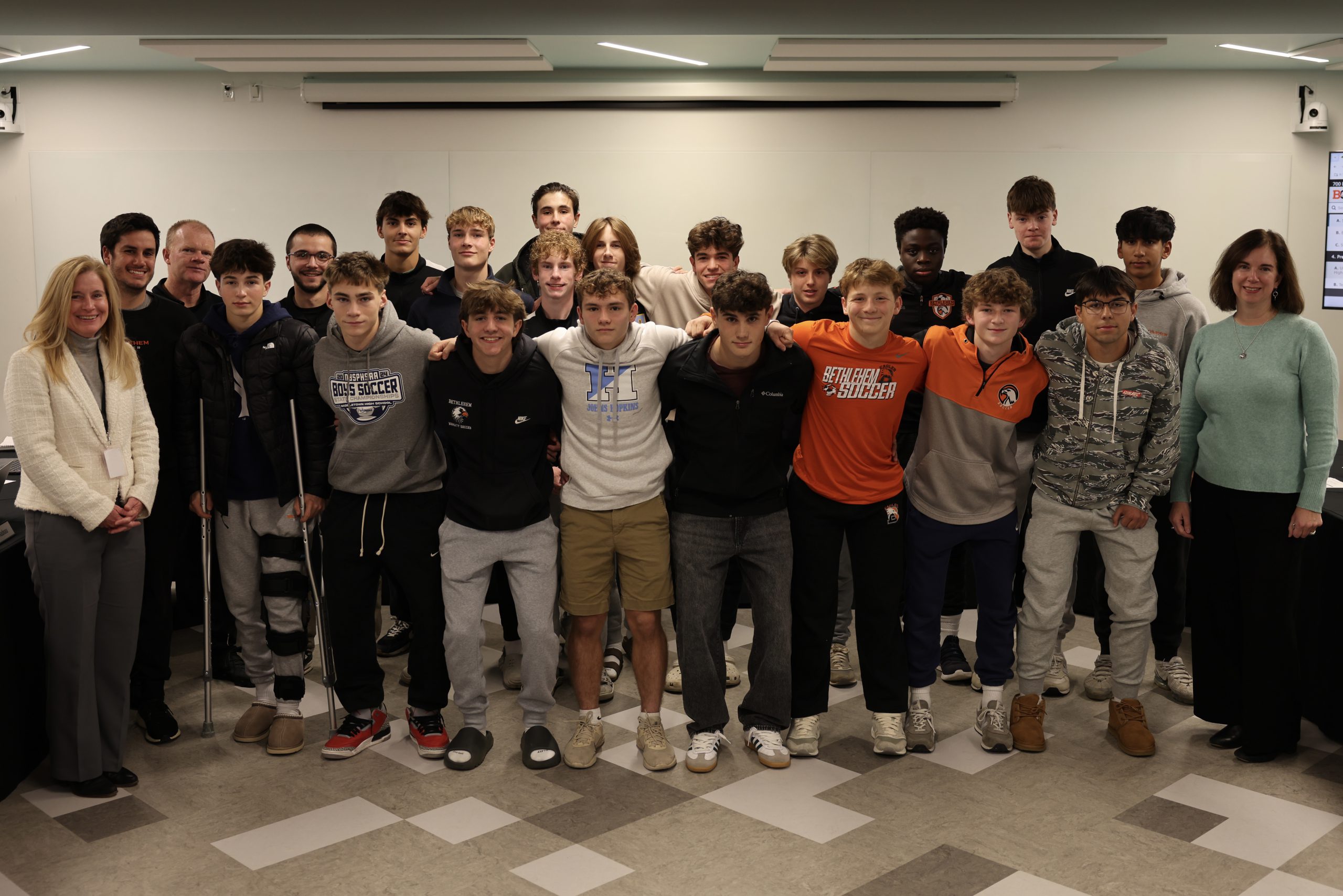 Photograph of Superintendent Jody Monroe, Board of Education President Holly Dellenbaugh and the BC Boys soccer team