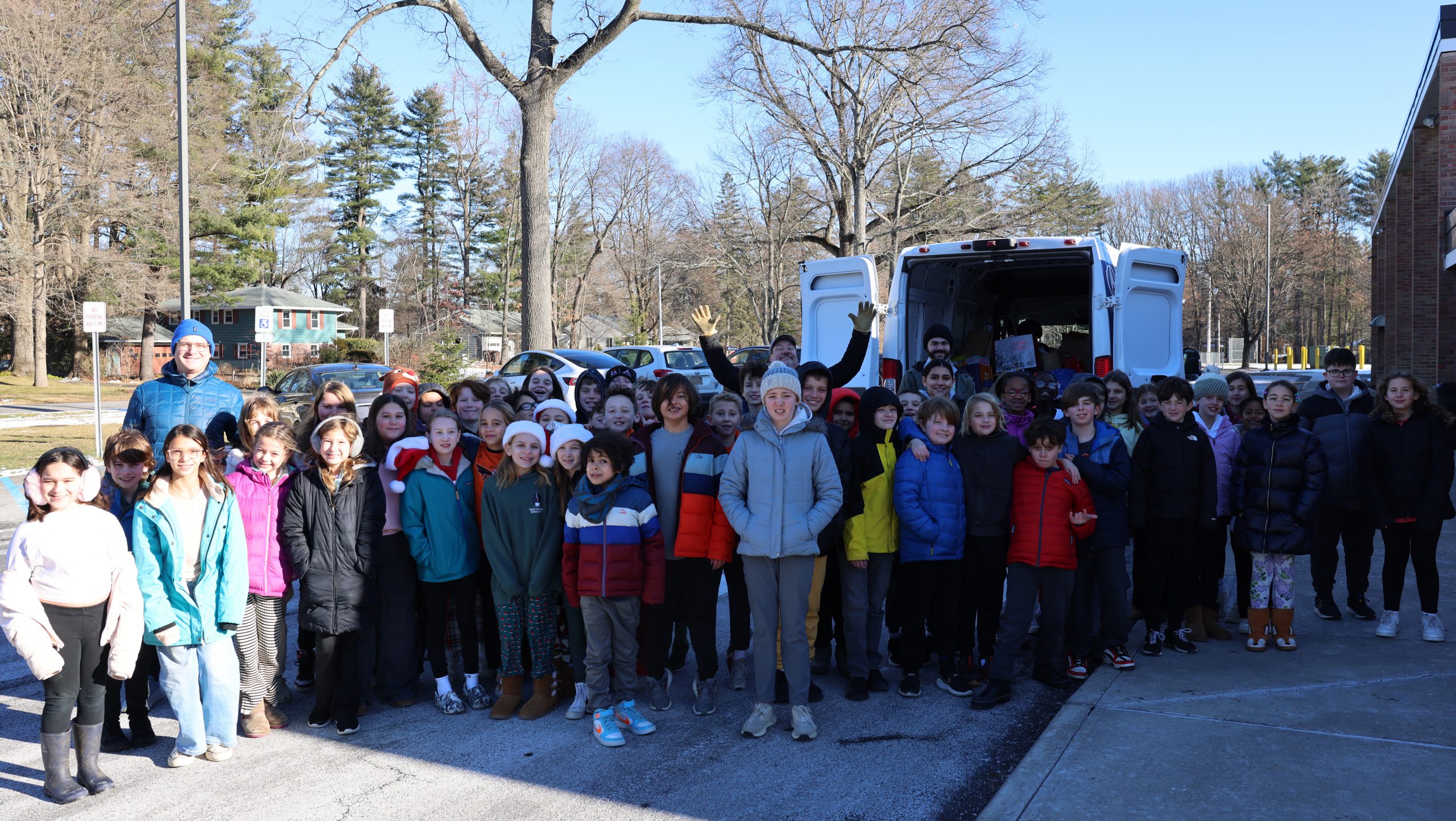 group of students in front of van