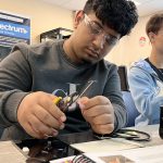 student holding tools